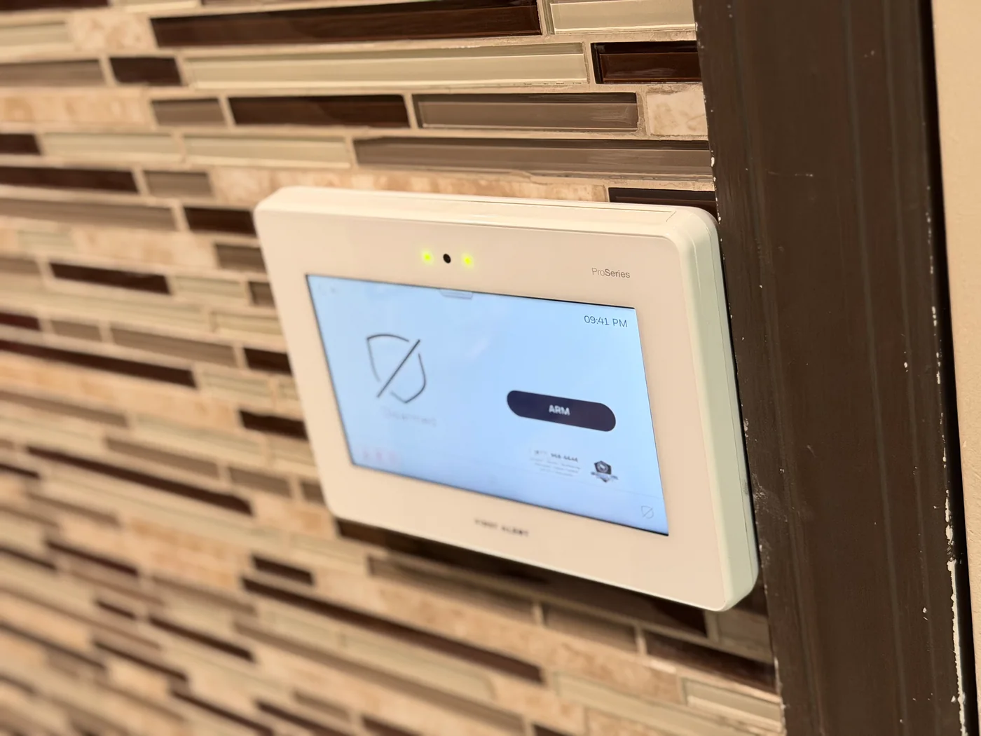 First Alert ProSeries alarm panel installed on a tiled wall by Familia Secured