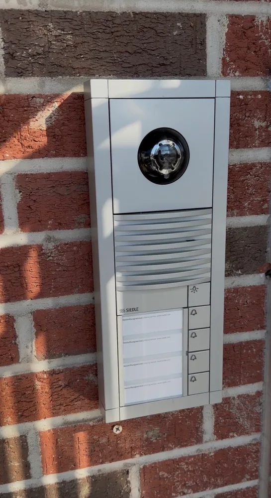 New Siedle video intercom installed by Familia Secured on the brick entrance wall